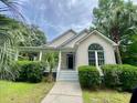 Beautiful home with manicured lawn and inviting front porch, ideal for relaxing outdoors at 5079 Coral Reef Dr, Johns Island, SC 29455