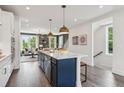 Modern kitchen with an eat in island, stainless steel appliances, and hardwood flooring at 552 Scholar Way, Summerville, SC 29486