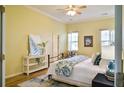 Serene bedroom featuring wood floors, comfortable bedding, and ample natural light at 6159 Fieldstone Cir, Charleston, SC 29414