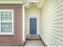 Close-up of the home's entrance, showcasing a stylish front door and brick accents at 7812 Spring Creek Rd, North Charleston, SC 29418