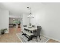 Well-lit dining area features a stylish table set, wood-look floors, and views of the living space at 9815 Seed St, Ladson, SC 29456