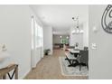 Bright dining room with modern chandelier, neutral tones, and an open floor plan at 9815 Seed St, Ladson, SC 29456