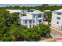 An aerial view of a three-story residence surrounded by lush landscaping with a white metal roof at 992 Key Colony Ct, Mount Pleasant, SC 29464
