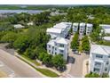 An aerial view showcasing a three-story home with lush greenery and multiple units, near the water at 992 Key Colony Ct, Mount Pleasant, SC 29464