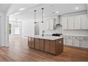 Modern kitchen island features pendant lighting, sink, and ample counter space at 0 Butterfly Ln, Awendaw, SC 29429