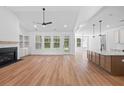 Open-concept living room with fireplace flows into modern kitchen with center island at 0 Butterfly Ln, Awendaw, SC 29429