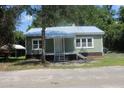 Charming cottage-style home featuring a light green exterior and a welcoming front porch at 103 Ann St, Saint George, SC 29477