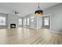 Bright open-concept living room with hardwood floors, fireplace, and abundant natural light at 104 Brightwood Dr, Huger, SC 29450