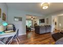 Open-concept living room with hardwood floors, gray sofas, and natural light flowing through the windows at 104 Jackson Rd, Ladson, SC 29456