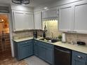 Well-lit kitchen featuring two-tone cabinets, modern appliances, and brick-patterned flooring at 106 Labrador Ct, Summerville, SC 29485