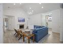 Bright living room featuring shiplap walls, fireplace, chandelier, and stylish furnishings at 1075 Wayfarer Ln, Charleston, SC 29412