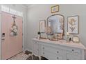 Warm foyer with a decorative dresser, gold mirror, and pink door, creating an inviting entrance at 108 Rusting Link Rd, Summerville, SC 29483