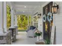 Charming front porch with comfortable seating, decorative wreaths, and inviting decor at 1130 Plantation Overlook Dr, Moncks Corner, SC 29461