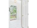 Bright entryway featuring white tile flooring and a view to the landscaped front yard at 1225 Dennis Blvd, Moncks Corner, SC 29461