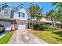 Townhome exterior with beautiful landscaping, driveway and garage at 143 Dorothy Dr, Charleston, SC 29414