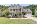 Inviting home featuring a well-manicured lawn, double porches and an attached two car garage at 1436 Lagoon Park Cir, Mount Pleasant, SC 29466