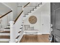 Inviting foyer with hardwood floors, staircase, and a stylish bench with decor at 1436 Lagoon Park Cir, Mount Pleasant, SC 29466