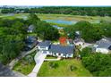Beautifully landscaped property with bright white home, and long driveway at 1468 N Relyea Ave, Charleston, SC 29412