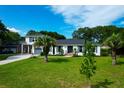 Beautiful home boasts an expansive lawn with manicured trees at 1468 N Relyea Ave, Charleston, SC 29412