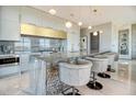 Sleek kitchen with marble countertops, pendant lighting, stainless steel appliances, and stylish bar stool seating at 149 Cooper River Dr, Mount Pleasant, SC 29464