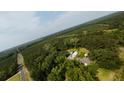 Scenic aerial view featuring home with a pond, barn, and wooded landscape at 1613 Cavanaugh Rd, Walterboro, SC 29488