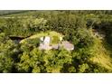 Overhead view of home with large barn and pond surrounded by mature trees at 1613 Cavanaugh Rd, Walterboro, SC 29488