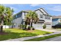 Beautiful two-story home with gray siding, a well-kept lawn, and a mature palm tree in the front yard at 1682 Mermentau St, Mount Pleasant, SC 29466