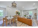Stylish open-concept living space featuring modern furnishings, a dining area, and plenty of natural light at 1685 Old Military Rd, Charleston, SC 29412