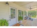 Inviting front porch with a seating area, ceiling fan, and views of the landscaped front yard at 1685 Old Military Rd, Charleston, SC 29412
