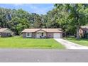 Inviting single-story home with a brick facade, an attached garage, and a lush green lawn at 208 Janice St, Goose Creek, SC 29445