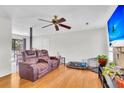 Comfortable living room featuring a plush reclining sofa, wood floors, and a ceiling fan at 208 Janice St, Goose Creek, SC 29445