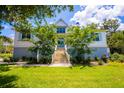Charming two-story home with manicured lawn and mature trees offering great curb appeal at 2312 Rushland Landing Rd, Johns Island, SC 29455