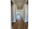 Inviting hallway featuring wood floors and natural light, leading to the living areas at 235 Denham St, Summerville, SC 29486