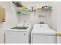 Efficient laundry room equipped with Samsung washer and dryer, shelving, and organized storage for cleaning supplies at 3257 Heathland Way, Mount Pleasant, SC 29466