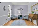 Charming office featuring hardwood floors, soothing gray walls, stylish decor, and natural light from arched windows at 3257 Heathland Way, Mount Pleasant, SC 29466