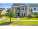 Inviting two-story home with a welcoming porch, green lawn, and sidewalk at 357 Parish Farms Dr, Summerville, SC 29486