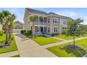 Charming two-story home featuring a double porch and well-manicured landscaping at 357 Parish Farms Dr, Summerville, SC 29486