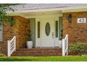 Inviting front entrance featuring a classic white door, elegant plants, and brick steps at 43 Heathwood Dr, Charleston, SC 29407