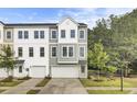 Two-story townhome with neutral siding, double-hung windows, and attached one-car garage at 501 Caledon Ct, Johns Island, SC 29455