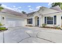 Beautiful single-story home showcasing a large driveway, attached garage, and covered entryway at 5406 Dwight Dr, North Charleston, SC 29420