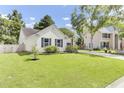 Well-maintained single-story home with lush lawn, driveway, and beautiful landscaping at 5406 Dwight Dr, North Charleston, SC 29420