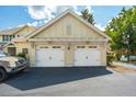 Detached two car garage with white doors and lovely exterior details at 5511 Colonial Chatsworth Cir, North Charleston, SC 29418