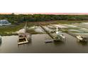 Drone view of covered dock featuring a boat lift and a tranquil waterfront setting at 627 Barbados Dr, Charleston, SC 29492