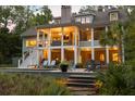Expansive backyard with covered patio, sparkling pool, and lush landscaping offering serene outdoor living at 627 Barbados Dr, Charleston, SC 29492