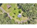 Aerial view of quaint home with spacious yard, surrounded by trees and adjacent properties at 7274 Commodore Rd, Hollywood, SC 29449