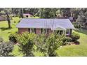 Charming brick home with well-maintained lawn, pretty shrubbery, and blue shutters at 7274 Commodore Rd, Hollywood, SC 29449