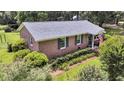 Charming brick home with well-maintained lawn, pretty shrubbery, and blue shutters at 7274 Commodore Rd, Hollywood, SC 29449