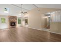Spacious living room with hardwood floors, brick fireplace, vaulted ceilings, and natural light at 8116 Long Shadow Ln, North Charleston, SC 29406