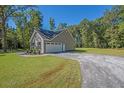 Spacious detached garage with ample parking space and a long driveway at 0 Peirce Rd, Ridgeville, SC 29472