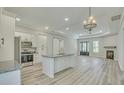 Open-concept kitchen and living room space with an island, stainless appliances and fireplace at 0 Peirce Rd, Ridgeville, SC 29472